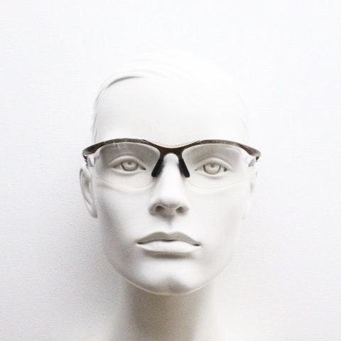 Bolle 90s vintage sports shield sunglasses. Aerodynamic clear lens wrap around half frame design in satin finish with tie string. Cycling