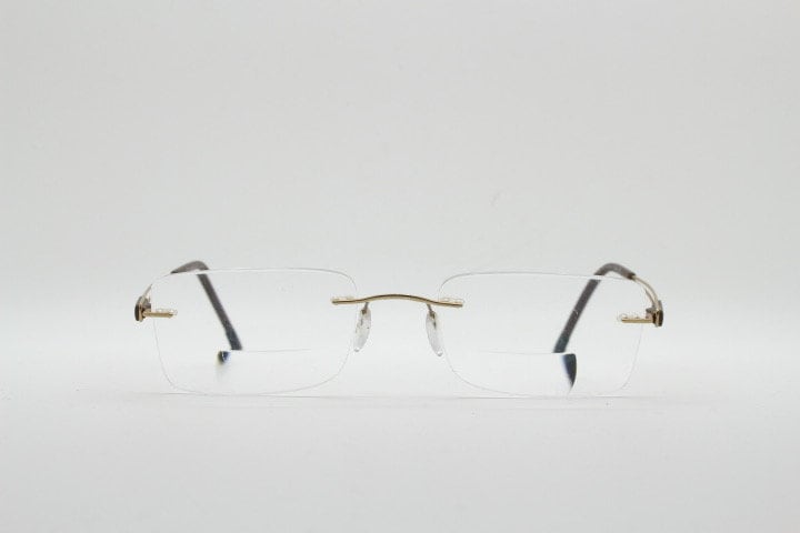 Silhouette rectangular frameless eye glasses model 7677 made in Austria. Minimal lightweight optical frame with golden trim. Prescription RX