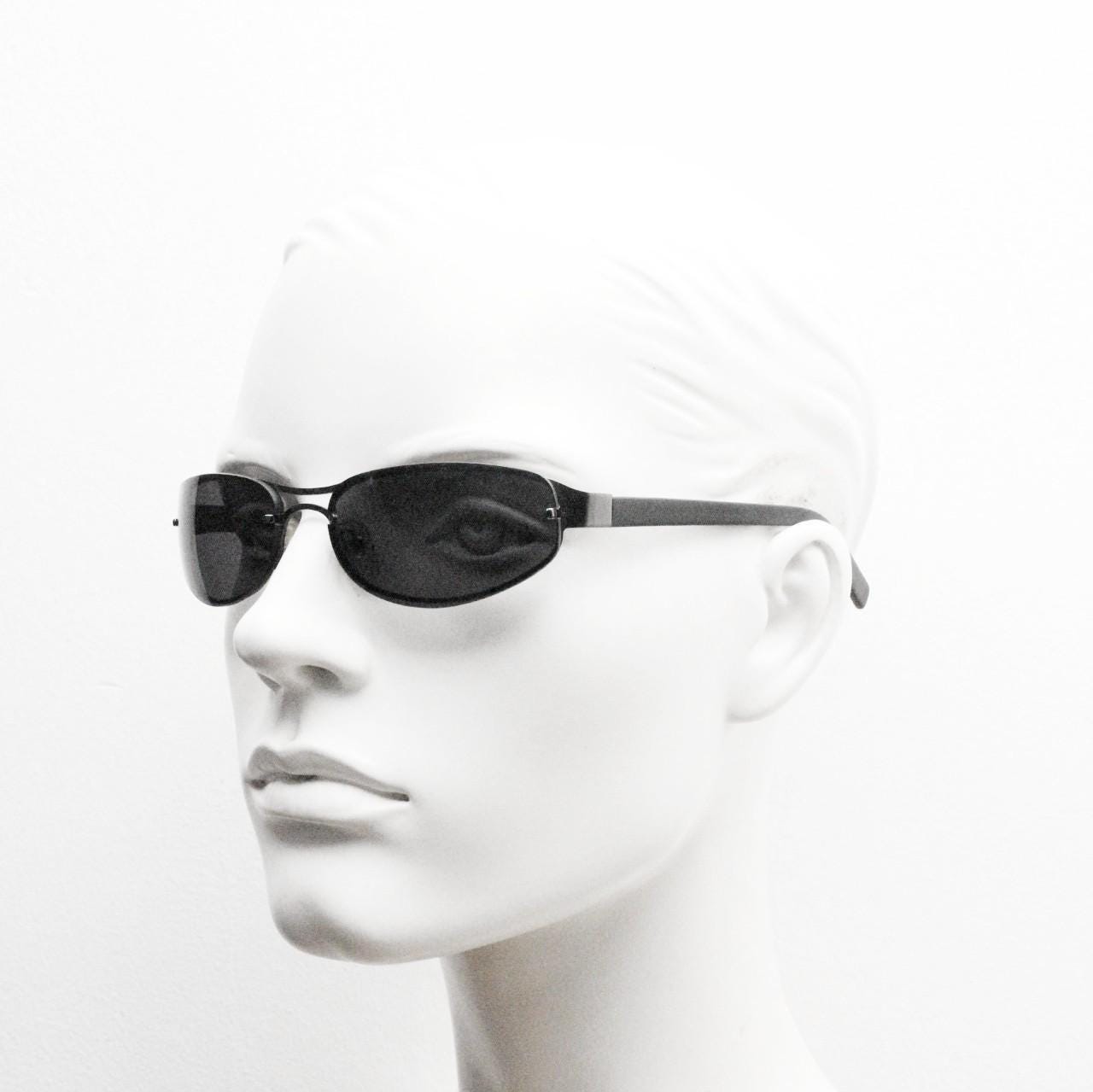 Y2K vintage small bug eye oval sunglasses. Gunmetal grey chrome metal frame with curved bug eye lenses and matt black arms. 2000's NOS