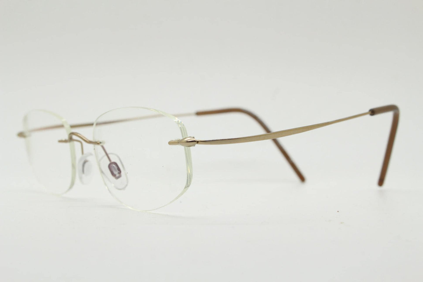 90s vintage angular oval frameless eye glasses. Minimal lightweight titanium optical frame. Flexible prescription RX spectacles