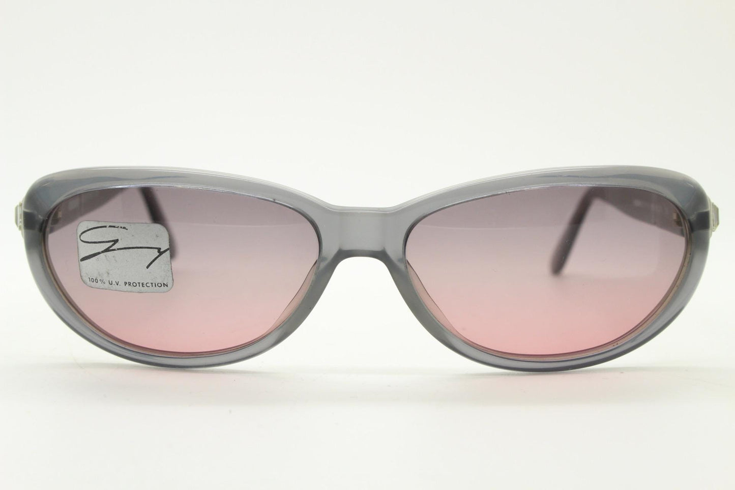 Genny 90s vintage oval cat eye sunglasses made in Italy. Transparent dark grey acetate frame with pink lenses. Womens NOS cateye. BNWT