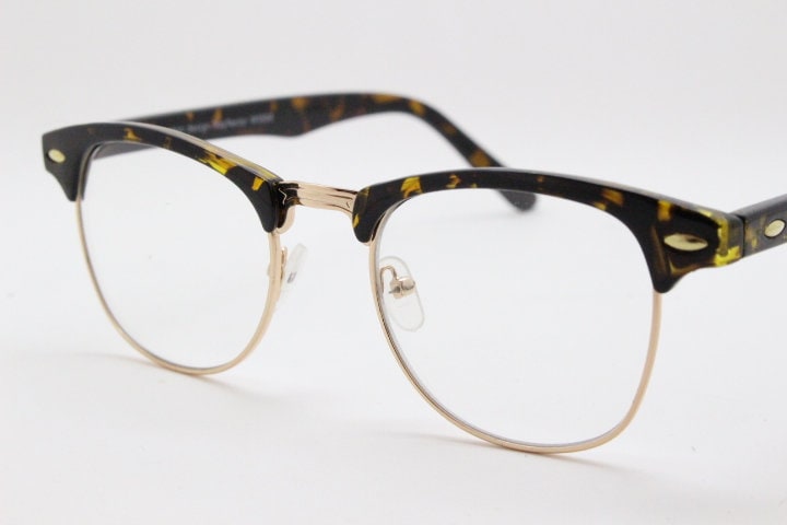 90s vintage half frame glasses. Tortoise browline eyeglasses in a gloss finish with gold underwire and clear lenses . Mens 50s, 60s design
