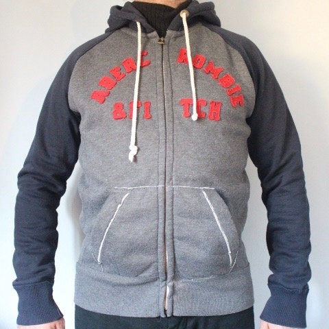 Abercrombie and Fitch grey and blue zipper sweat hoody with large red spell out patch letter chest logo. Mens all cotton medium size