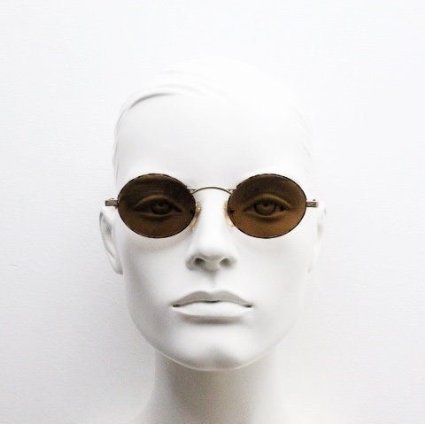 Armandos 90s vintage oval sunglasses made in Italy. Enamelled honey tortoise front with ornate tooled metal arm patterns. NOS