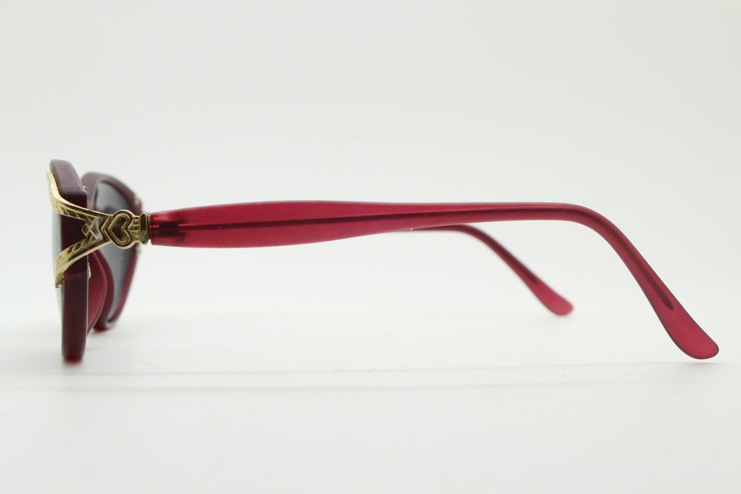 80s vintage Revlon cat eye sunglasses. Women's dark pink transparent frosted frame with golden Y fork ornate temples. 90s cateye. NOS