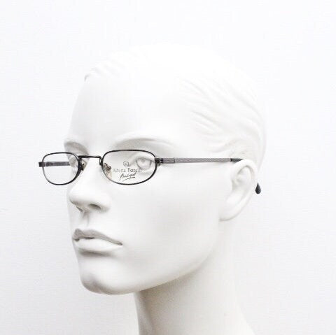Alberta Ferretti 90s vintage oval eye glasses made in Italy. Small grey metal optical frame with ornate arm pattern. Prescription RX. NOS