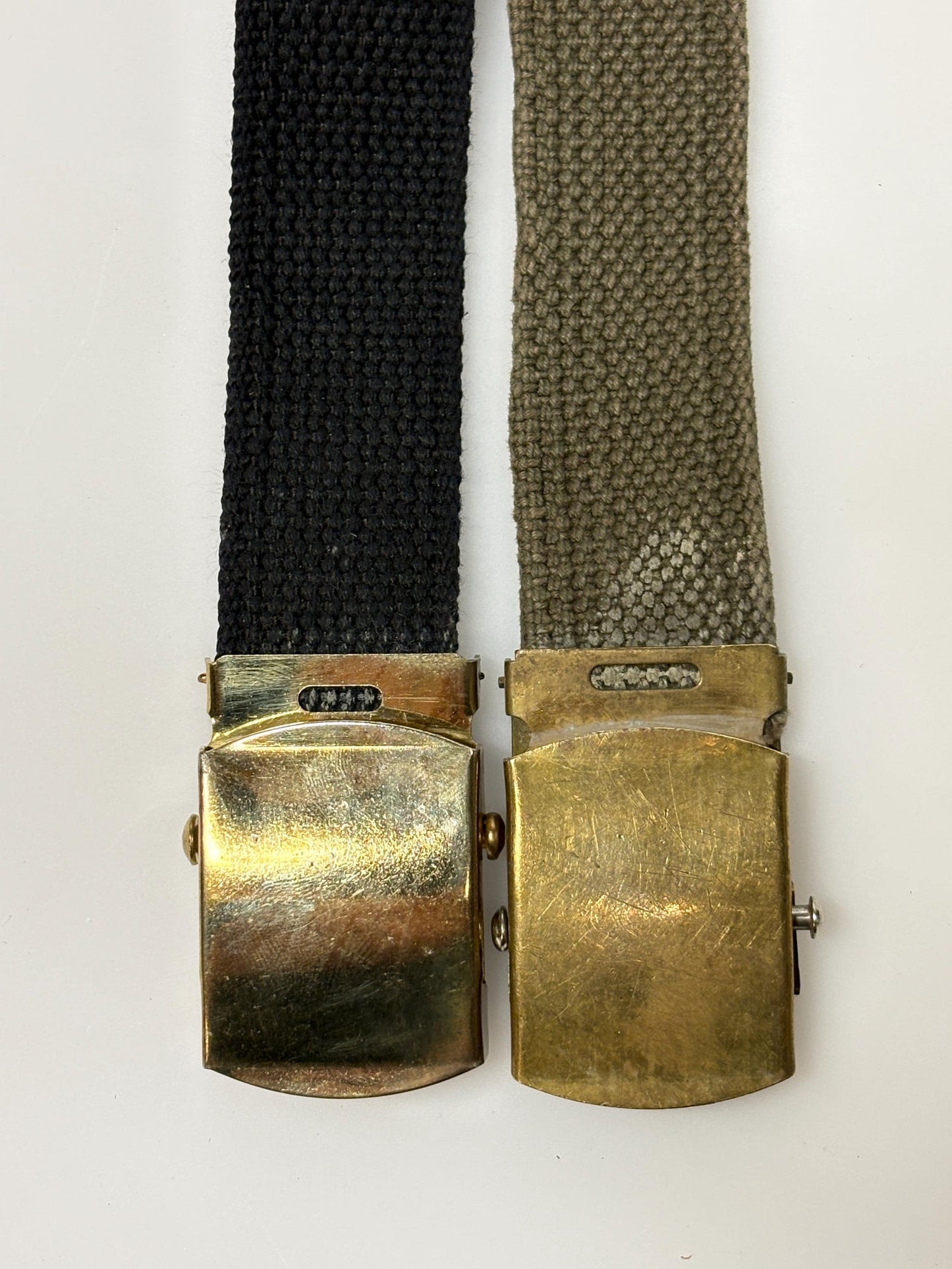 2 x bundle 80s vintage canvas army belts. One black plus one khaki green no holes format. Slide lock gold buckle. Webbing. Fully adjustable