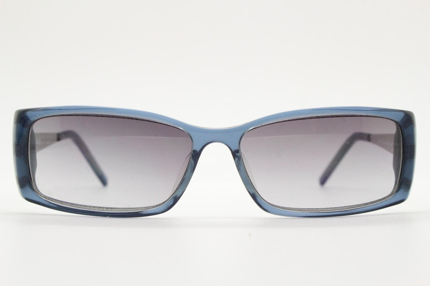 90s vintage rectangular low profile sunglasses by Storm. Transparent grey acetate front with brushed steel arms. NOS. 2000s