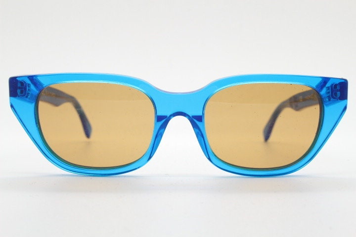 Retrosuperfuture thick cat eye sunglasses hand made in Italy. Intense blue acetate chunky frame with contrasting brown lenses. BNWOT