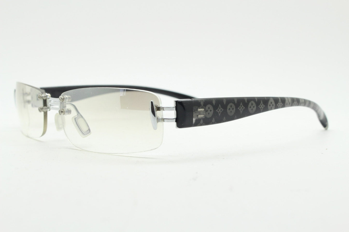 Y2K vintage frameless sunglasses. Silver chrome trim with patterned arms and extra light tone graduated curved mirror lenses. 2000's. 90s