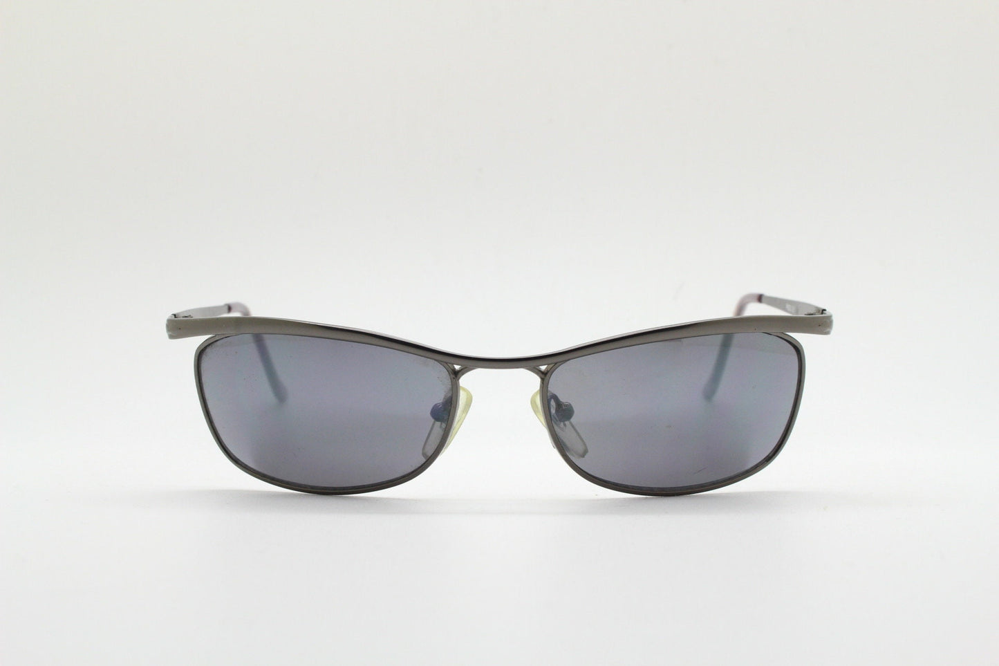 Y2K vintage curved oval sunglasses. Minimal grey chrome metal aerodynamic sport shaped frame. 2000's. 00's NOS