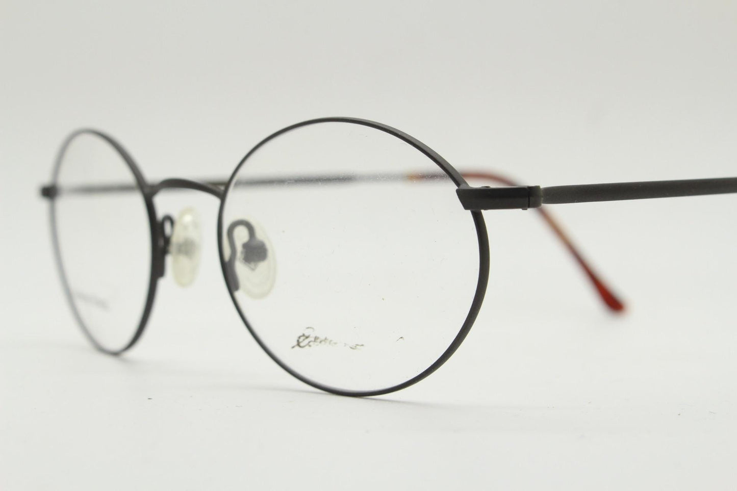 Eddie Bauer 90s vintage oval eye glasses. Minimal black matt finish optical frames with kinked arms. Stainless steel spectacles. NOS