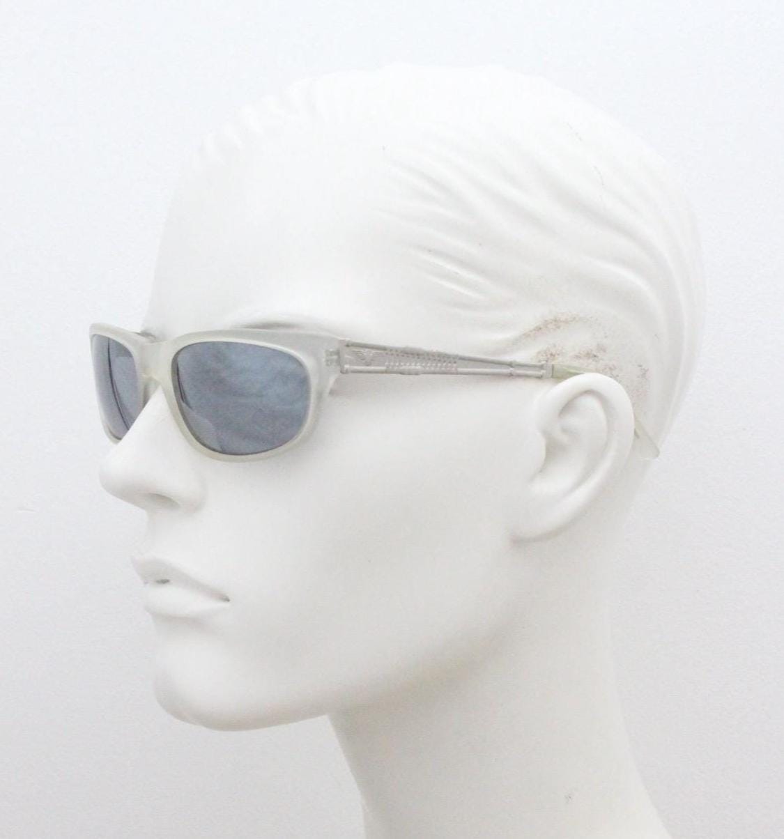 Dakota Smith vintage 90s futuristic sunglasses. Transparent frosted wrap around shield frame with mirror lenses and ornate arm patterns