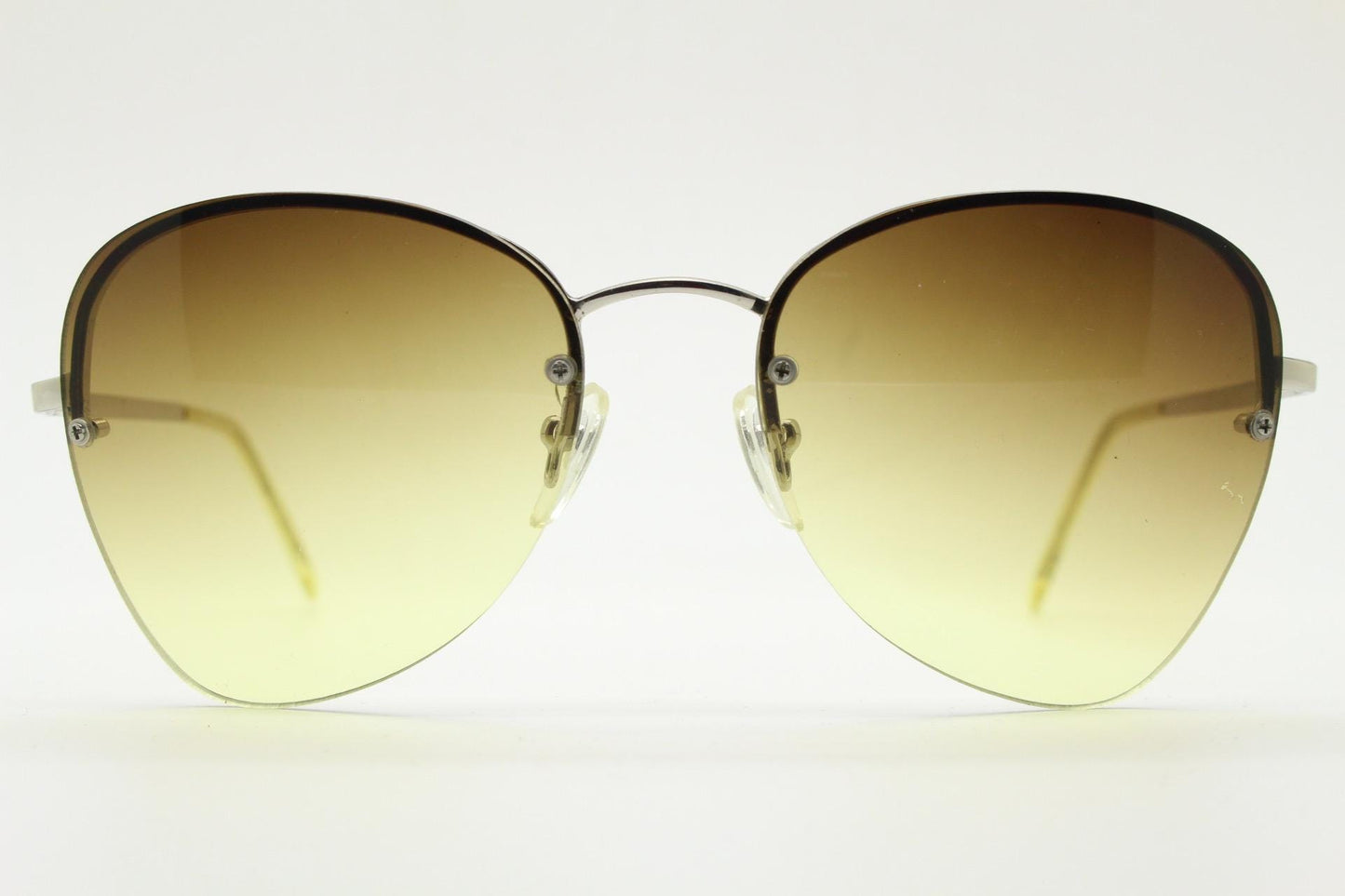 90s vintage modified teardrop aviator sunglasses. Minimal metal silver chrome half frame with compelling lenses. Teardrop aviators. NOS