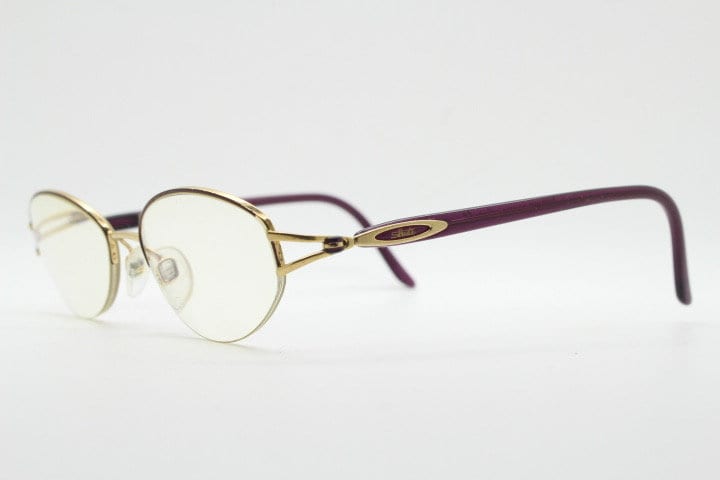 Silhouette oval half frame eye glasses model 6566 made in Austria. Minimal optical frame with gold trim deep purple arms. Prescription RX