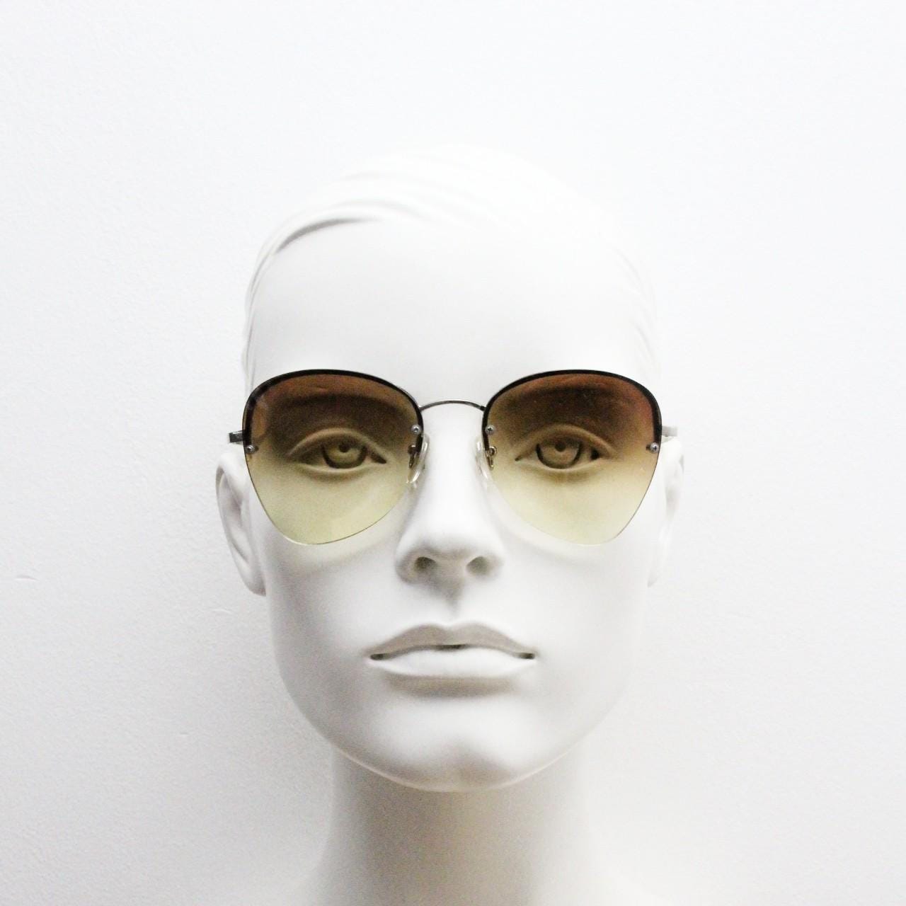 90s vintage modified teardrop aviator sunglasses. Minimal metal silver chrome half frame with compelling lenses. Teardrop aviators. NOS