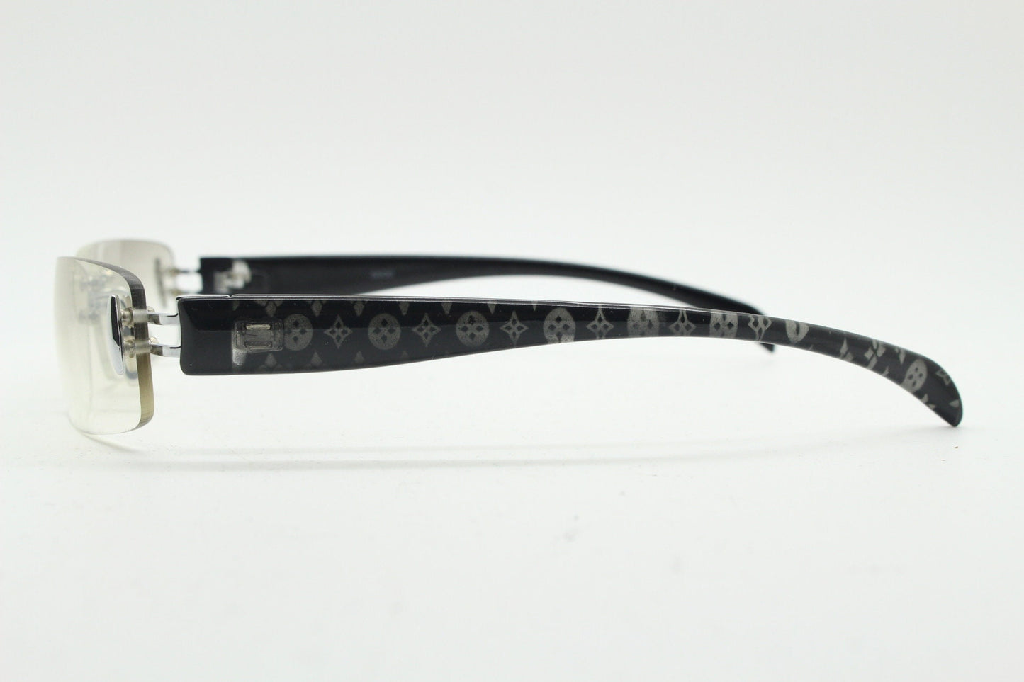 Y2K vintage frameless sunglasses. Silver chrome trim with patterned arms and extra light tone graduated curved mirror lenses. 2000's. 90s