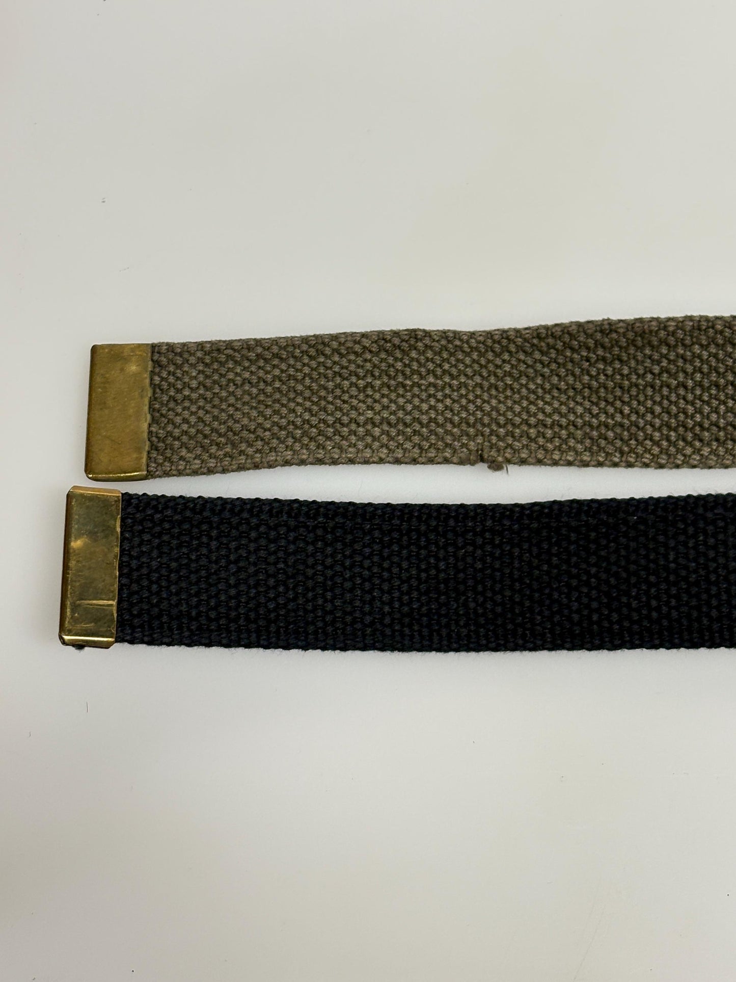 2 x bundle 80s vintage canvas army belts. One black plus one khaki green no holes format. Slide lock gold buckle. Webbing. Fully adjustable