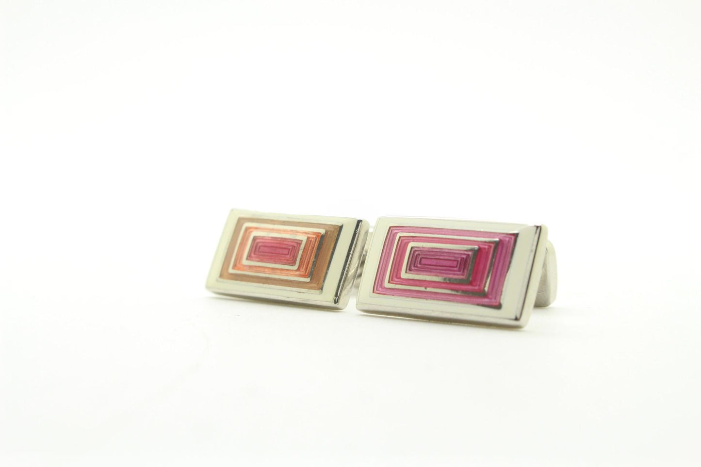 Vintage rectangular cuff links made in England by Herringbone. Solid metal construction with fine enamelled white, pink and peach tones. NOS