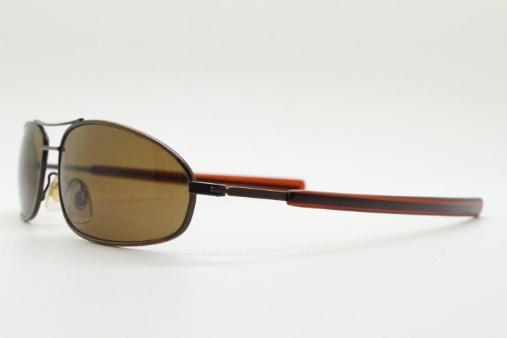 90s vintage abstract rectangular sunglasses. Metallic bronze satin finish frame with brown lenses and straight arms. 2000's. NOS aviator