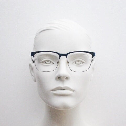 Karl Lagerfeld squared wayfarer shape eye glasses. Navy check pattern arms with satin finish brow optical frames. Prescription eyeglasses.