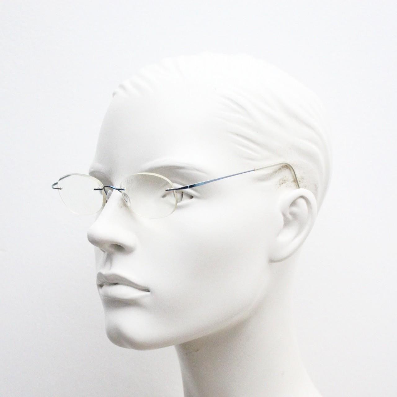 Frameless vintage oval eye glasses. Extremely minimal lightweight blue titanium optical frame with springy hingeless arms. 2000s
