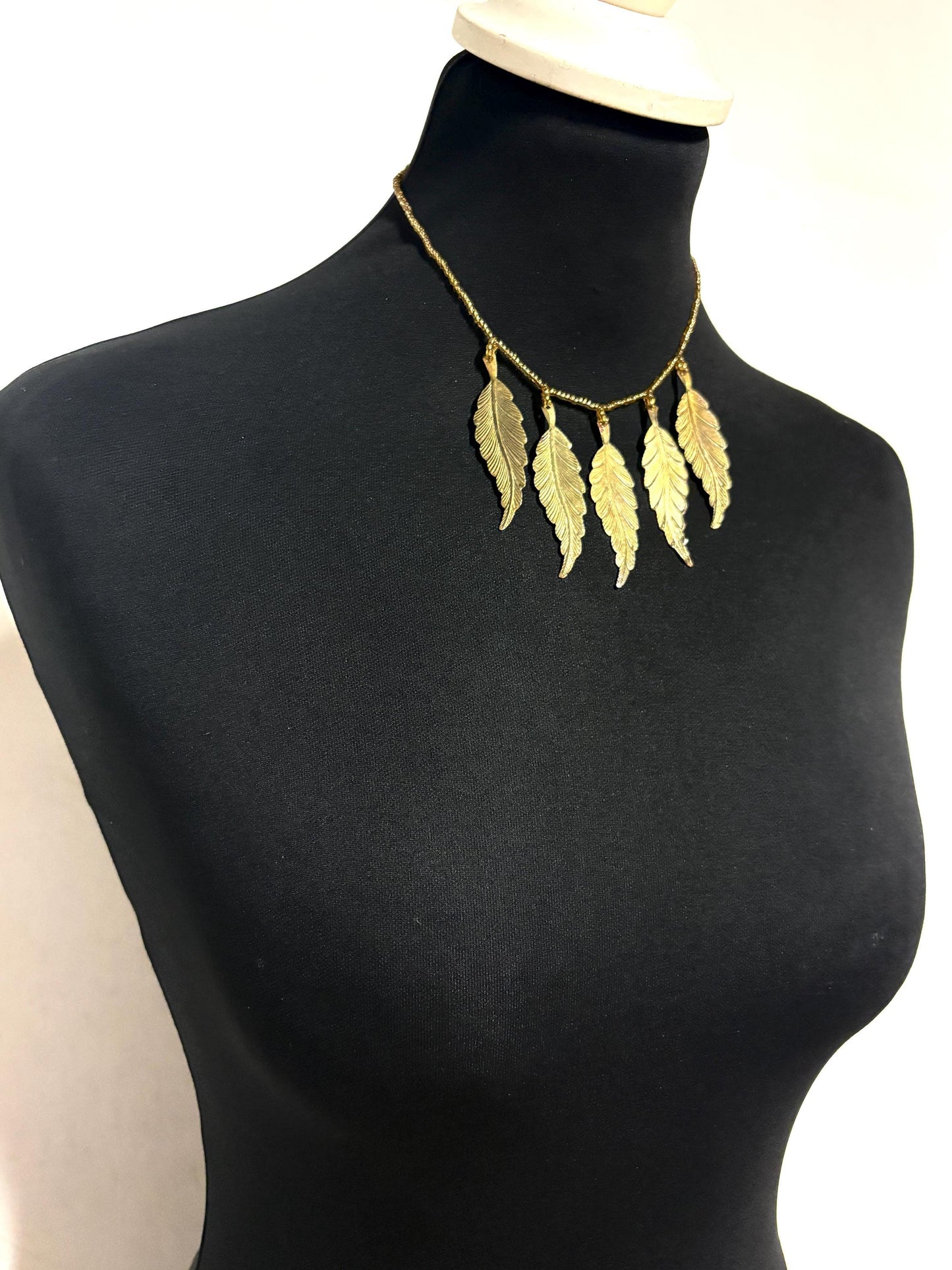 80s vintage gold beaded necklace with large dangling leaves . Charming statement piece. Country and western. Native american