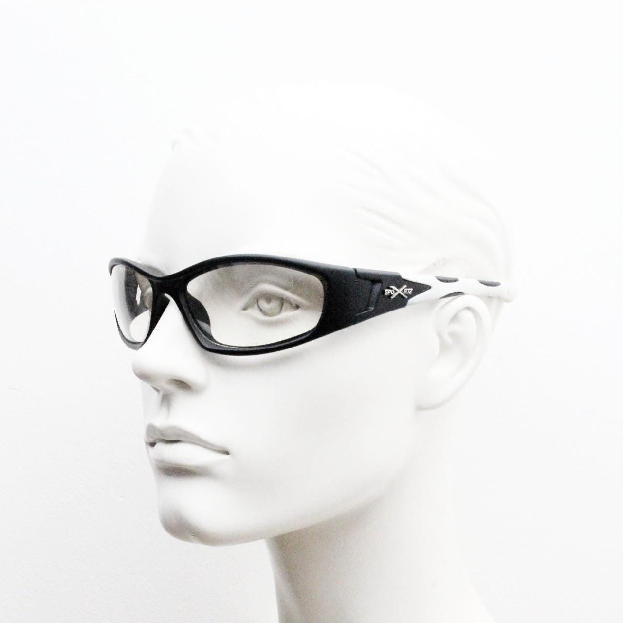 90s vintage sports sunglasses. Black matt aerodynamic wraparound with straight white rubber arms and light tone lenses. Y2K rave shield