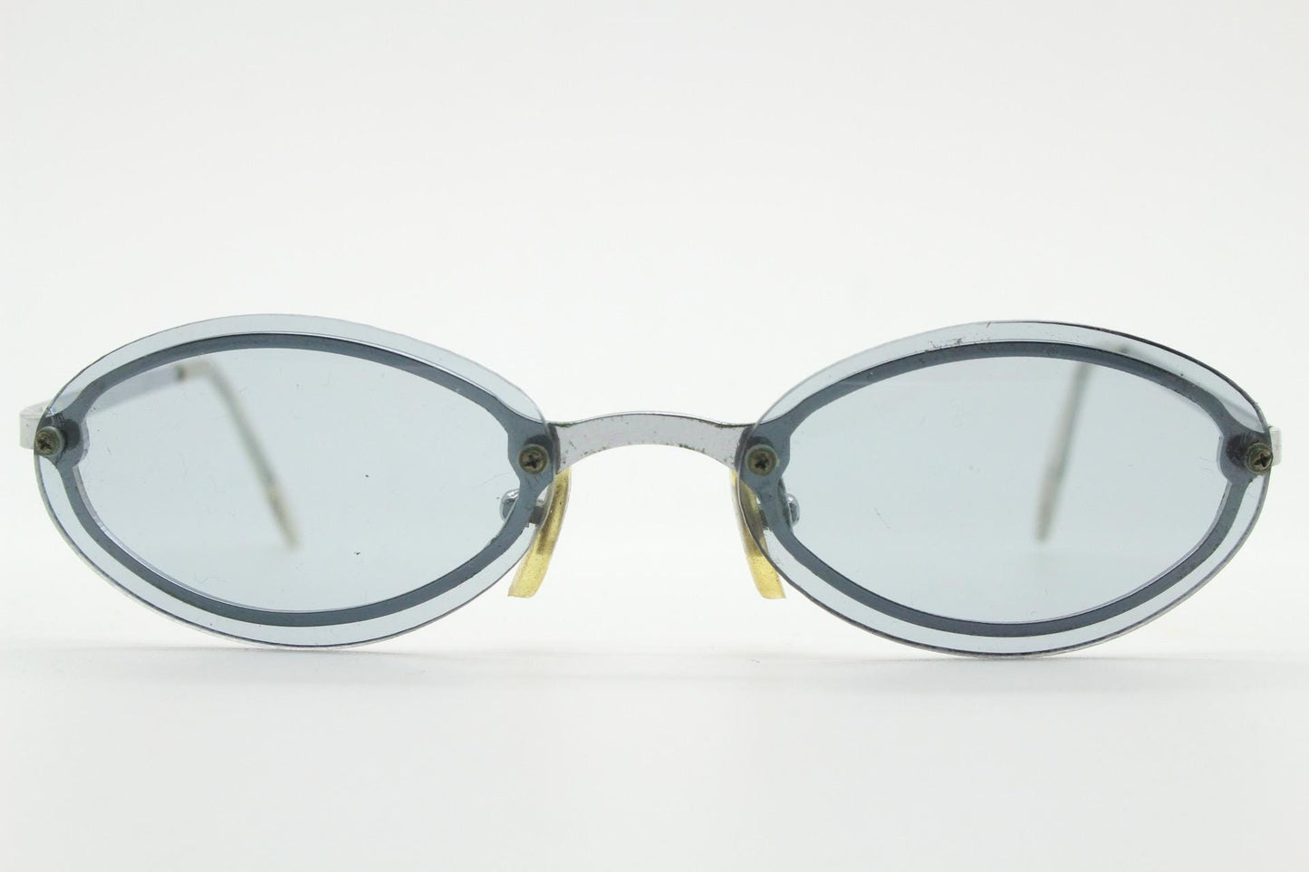 90s vintage small oval sunglasses. Minimal silver chrome metal frame with overlapping light tone grey lenses. Micro. Steampunk
