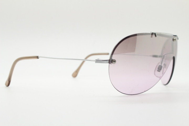 Y2K vintage visor shield sunglasses. Silver chrome half frame with pink wraparound mono lens and mirror glaze. Mini mask. 00's. 2000's NOS