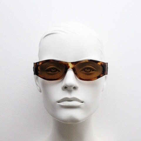 90s vintage oval sunglasses. Low profile transparent tortoise frame with massive bronze metal arm crests BNWT. Unused NOS