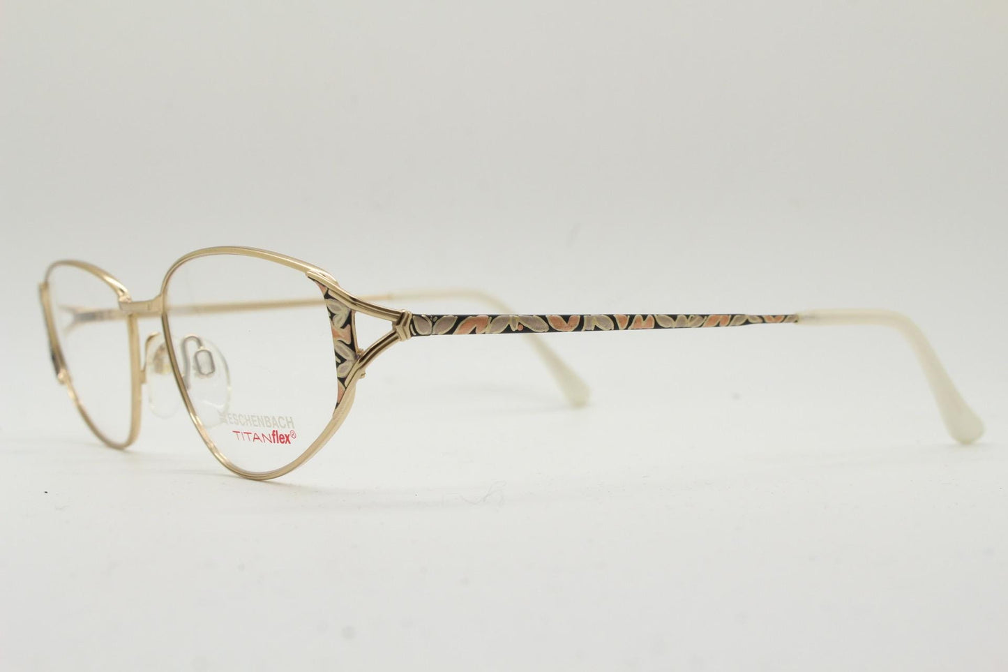 Eschenbach 90s vintage cropped cat eye glasses. Low profile gold metal optical frame with tasteful metallic arm pattern. Prescription. NOS