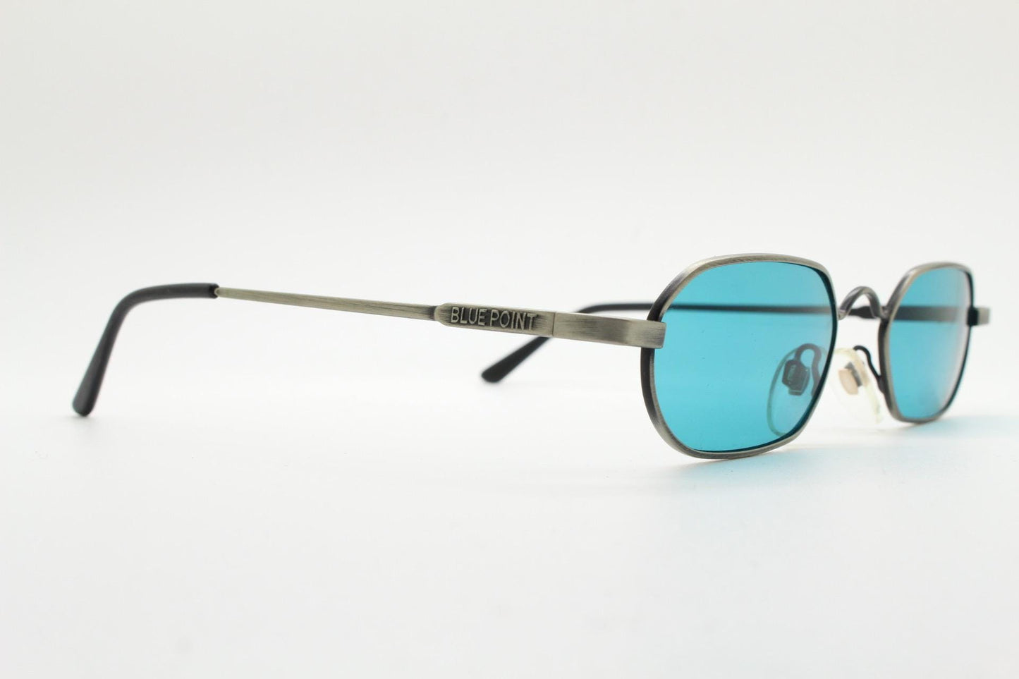 90s vintage small angular oval sunglasses by Blue Point. Low profile brushed bronze finish metal frame with turquoise blue lenses, NOS