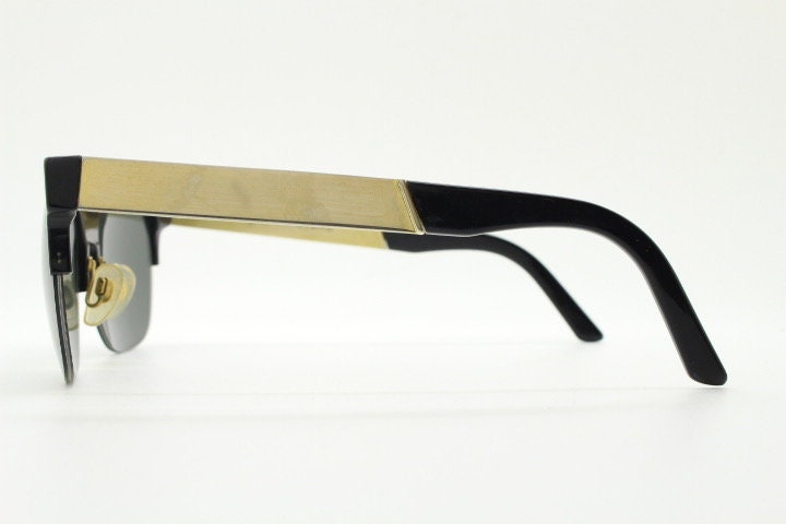 Retrosuperfuture vintage flat top half frame sunglasses hand made in Italy. Black gloss acetate front with tall golden arms