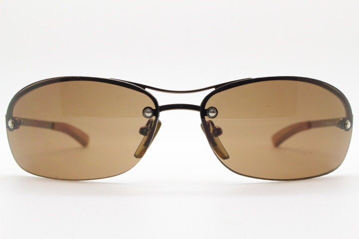 Y2K vintage oval aviator sunglasses. Metallic brown chrome half frame with mid tone curved bug eye lenses and straight arms. 2000's. NOS