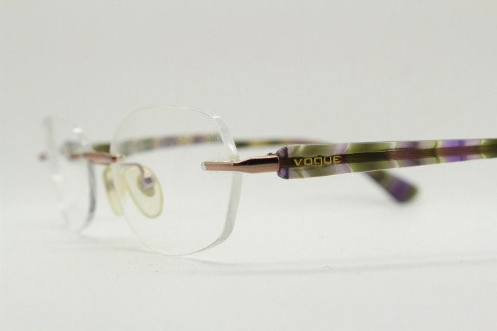 Vogue vintage frameless oval eye glasses. Transparent acetate arms with purple and green tones. Minimal Prescription RX Optical frame