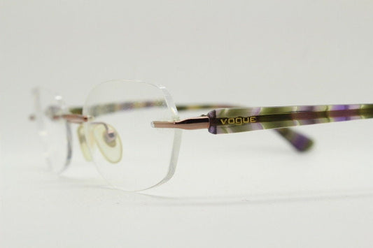 Vogue vintage frameless oval eye glasses. Transparent acetate arms with purple and green tones. Minimal Prescription RX Optical frame