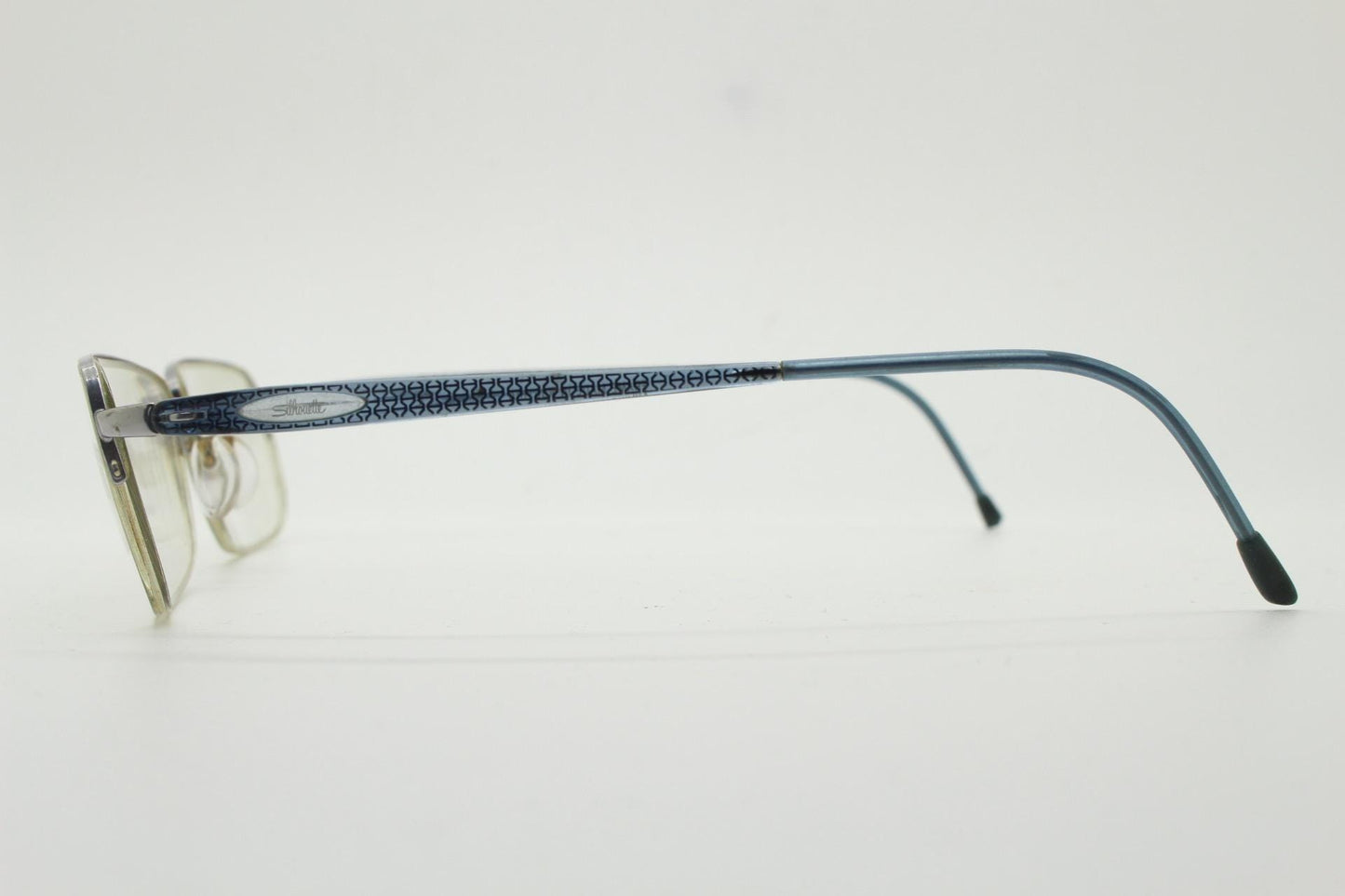 Silhouette rectangular half frame eye glasses made in Austria. Minimal brow line optical frame with patterned transparent arms. Prescription
