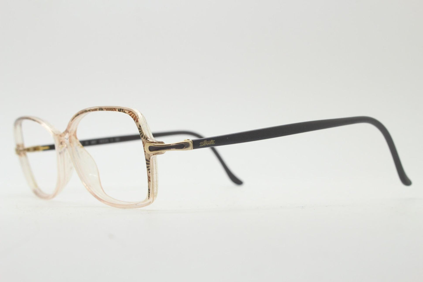 Silhouette 80s vintage oval eye glasses made in Austria. Transparent crystal optical frame with giraffe arm print. Prescription RX