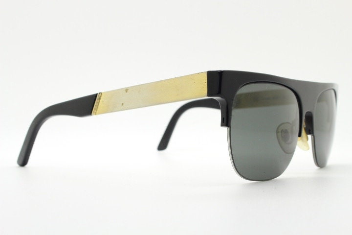 Retrosuperfuture vintage flat top half frame sunglasses hand made in Italy. Black gloss acetate front with tall golden arms
