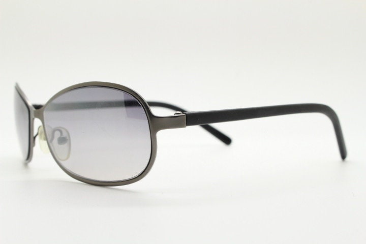 Y2K vintage mini bug eye sunglasses. Curved gunmetal grey flat metal frame with black matt arms and graduating lenses. Unused 2000s NOS