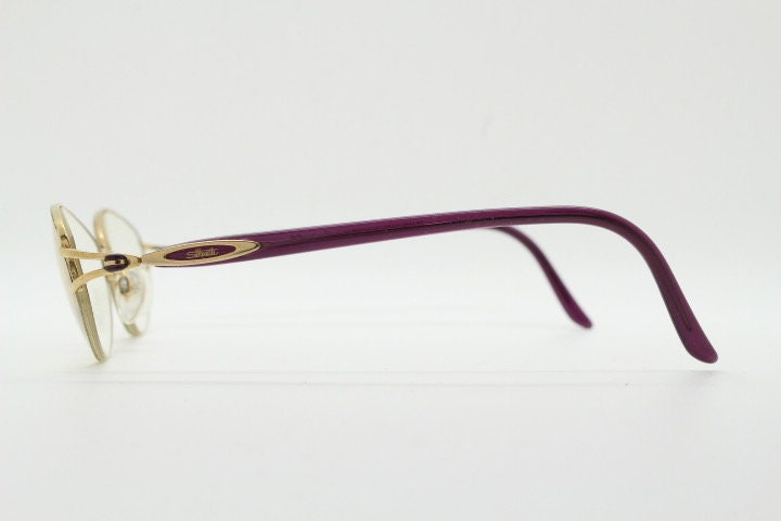 Silhouette oval half frame eye glasses model 6566 made in Austria. Minimal optical frame with gold trim deep purple arms. Prescription RX