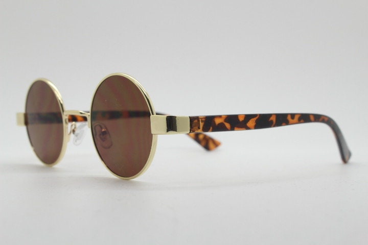 90s round vintage sunglasses. Gold 1920's style frame with tortoise arms and brown lenses. Unused. NOS. Steampunk