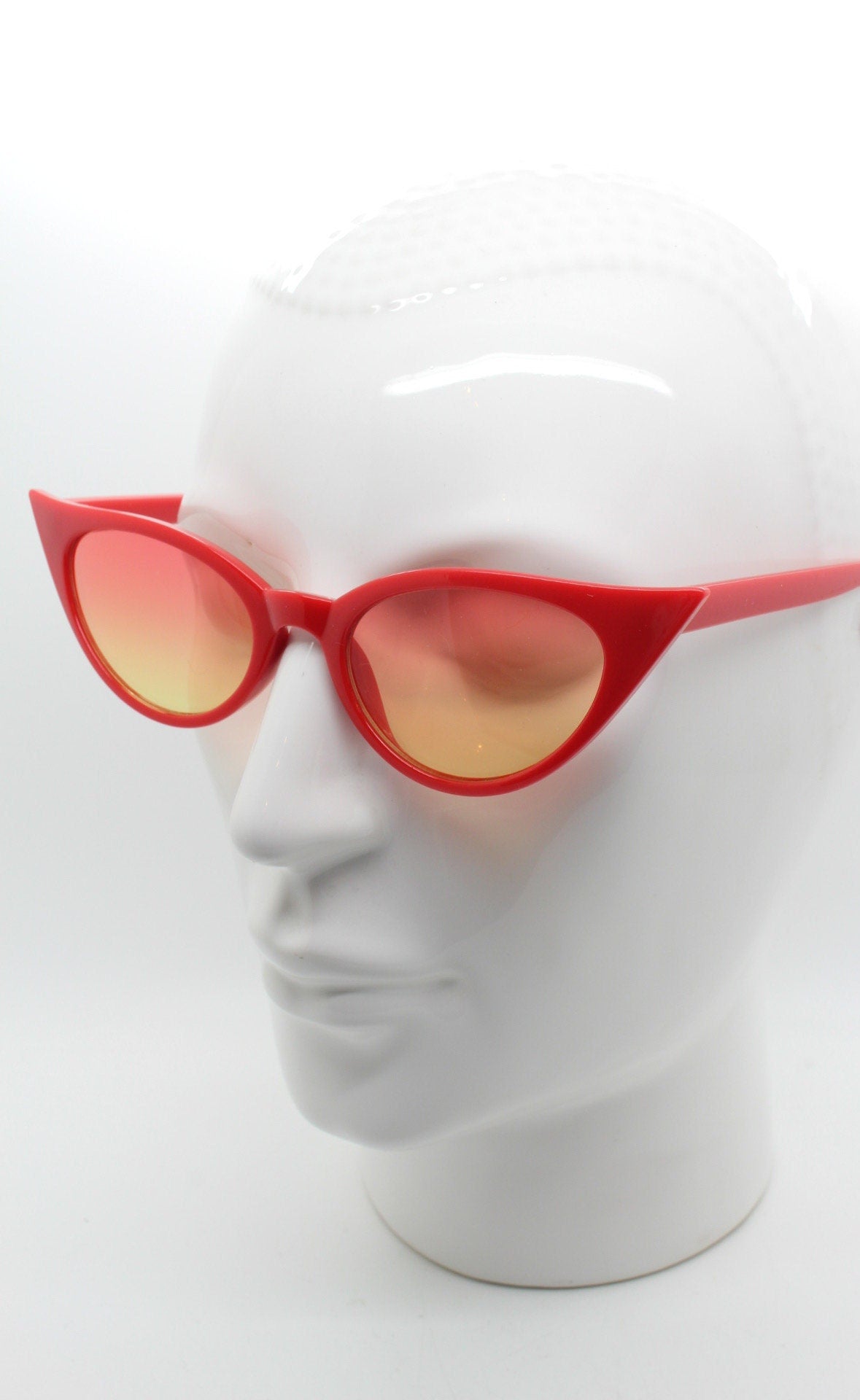 Y2K vintage pointed cat eye sunglasses. Red slender frame with graduating lenses. Womens 50s style rockabilly, pin up shades