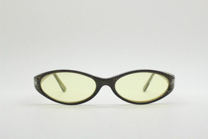 90s vintage abstract oval sunglasses. Thick curve around black frame with psychedelic yellow crackle print. Mini mask. Cosplay NOS