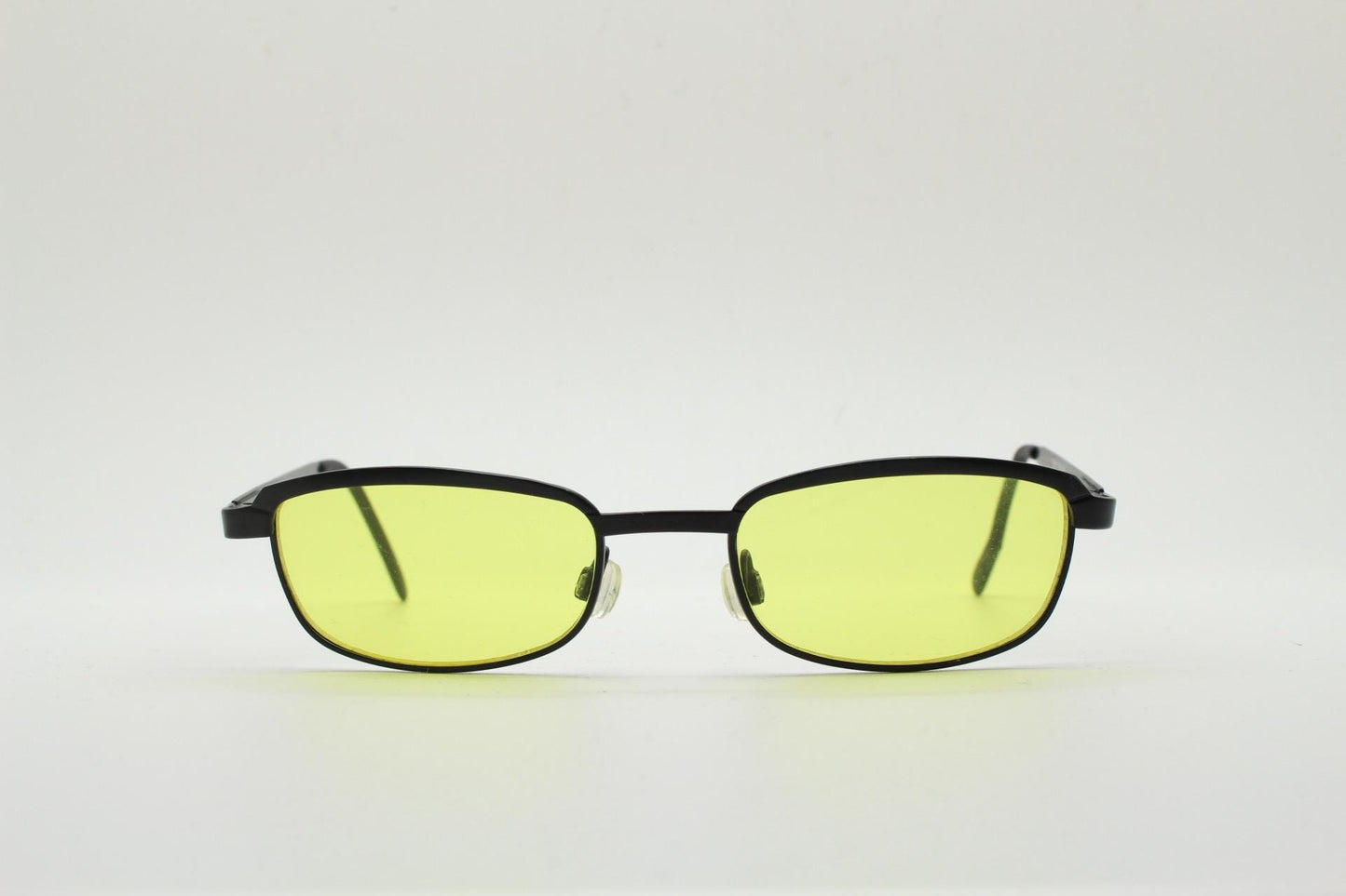 Vintage small rectangular sunglasses. Authentic quirky 90s design in a matt black solid metal frame with bright yellow lenses. 2000s. NOS