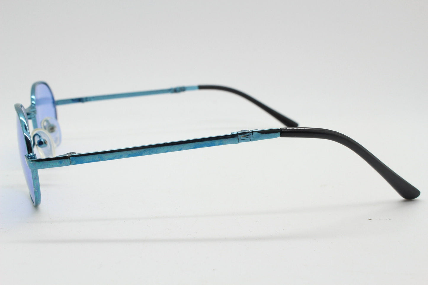 Y2K micro foldable oval sunglasses. Sky lenses in a small folding matching coloured compact frame. Folder. Rave 2000s. 90s NOS