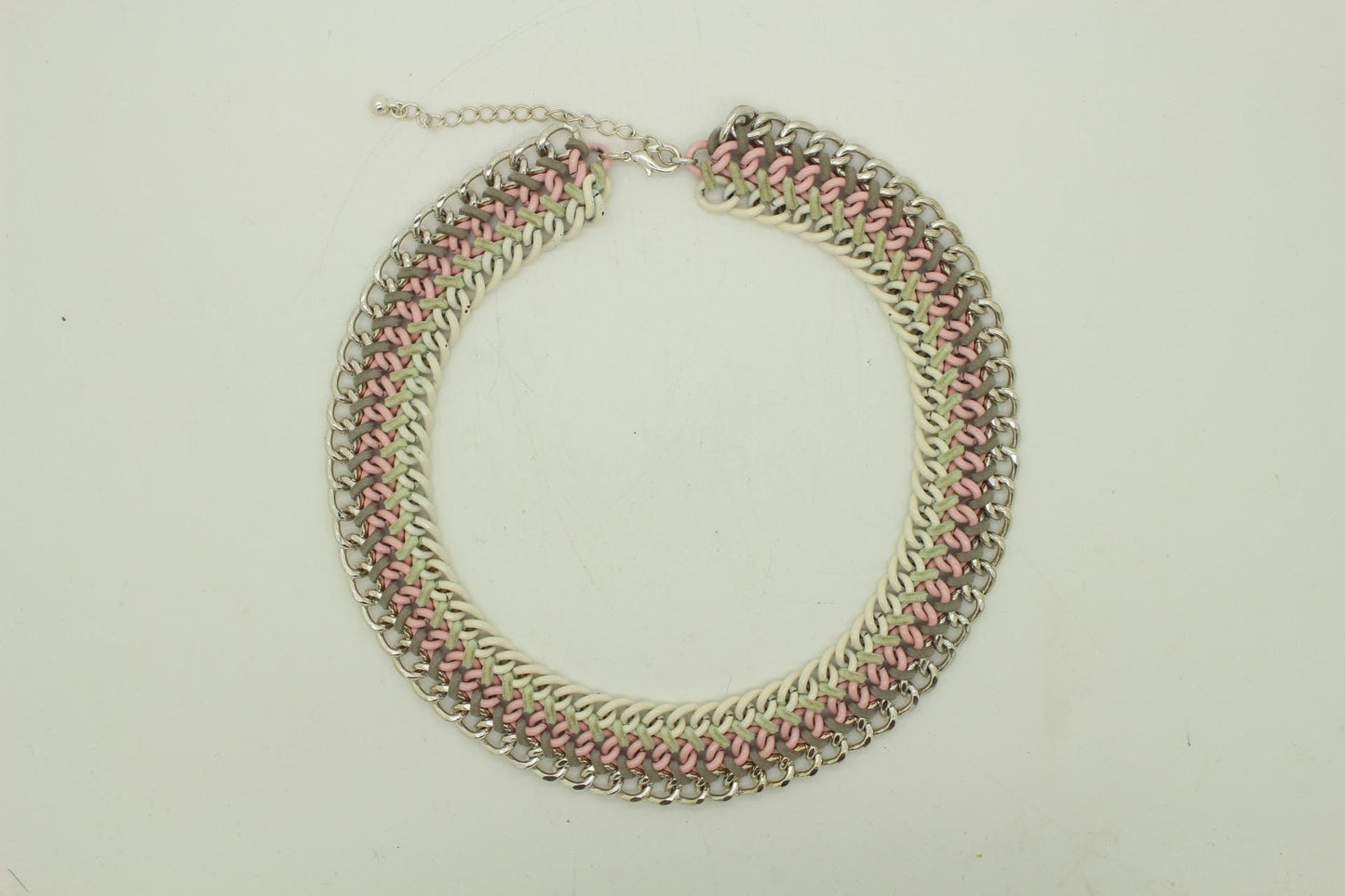 90s vintage 3 tier chain necklace. Solid metal construction in silver, pink, and white tones with grey rubber bonds. Adjustable back