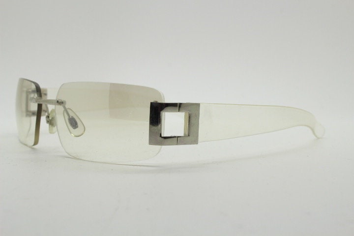 Y2K vintage wraparound sunglasses. Minimal frameless light tone curved mirrored lenses with silver chrome trim. 2000's. 90s. 00s. NOS