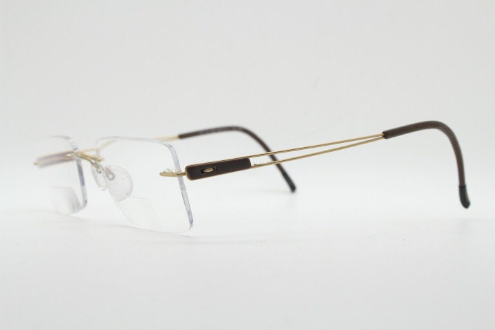 Silhouette rectangular frameless eye glasses model 7677 made in Austria. Minimal lightweight optical frame with golden trim. Prescription RX